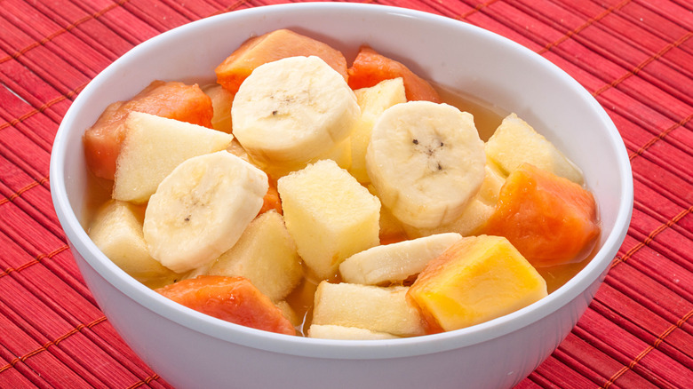 Brazilian fruit salad in white bowl on red tablecloth