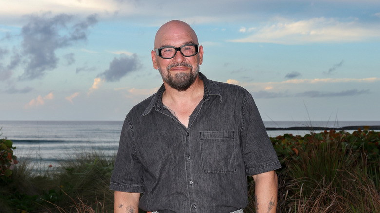 Chef Michael Symon poses in front of the ocean