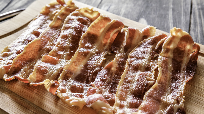 Bacon on wooden cutting board