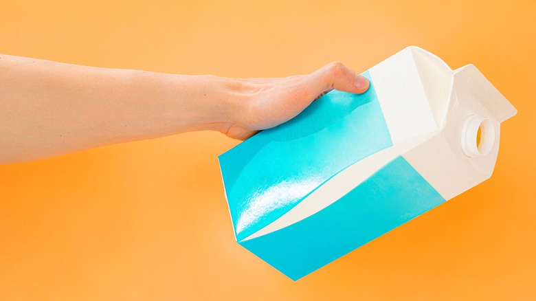 Milk carton on orange background