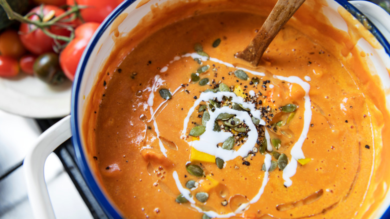 Bowl of homemade soup topped with seeds.
