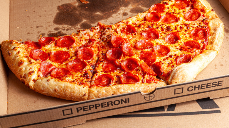 A half-eaten Costco pepperoni pizza on a Costco pizza box