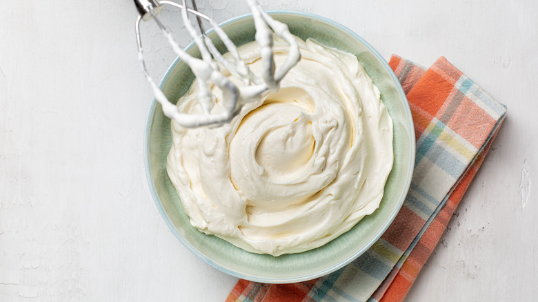 Beaters coming out of bowl of whipped cream