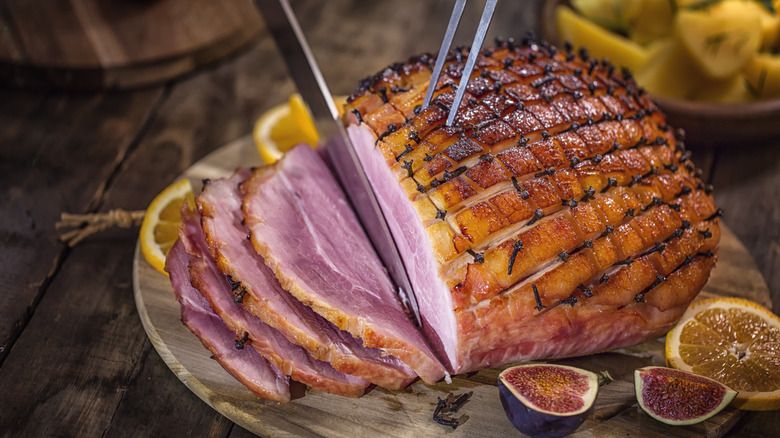 Ham studded with cloves being carved