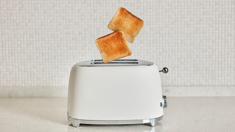 Toast pops out of a toaster.