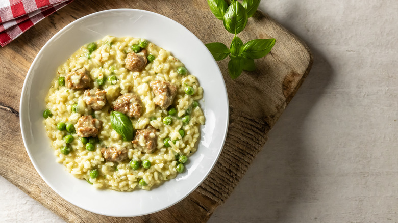 Risotto in a plate on a wooden cutting board