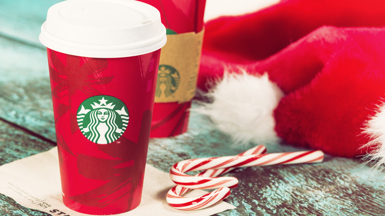 Starbucks holiday cups with Christmas background