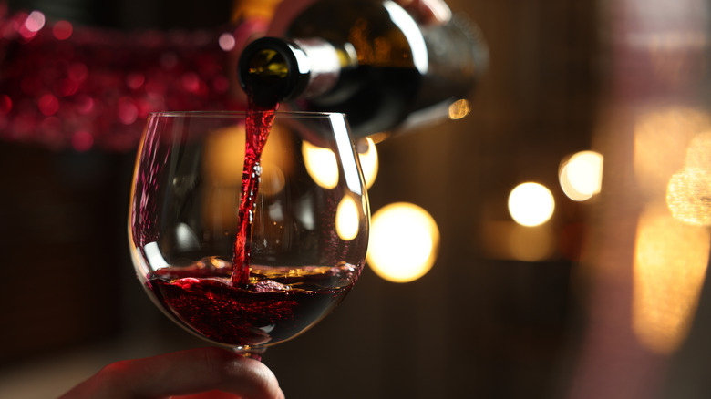 Pouring red wine into a glass