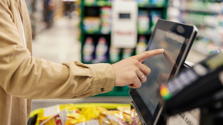 shopper at self-checkout lane