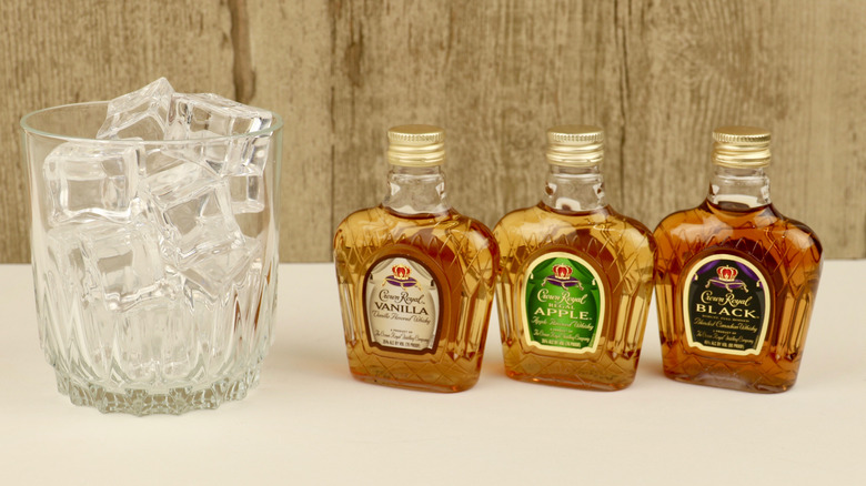 Several different bottles of Crown Royal whiskey.