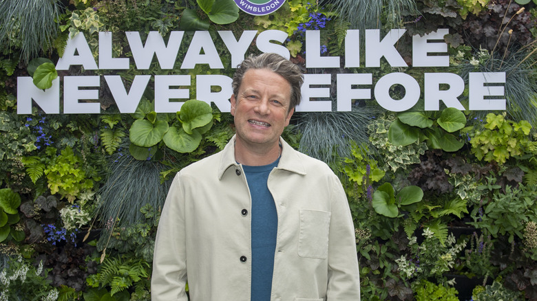 Jamie Oliver smiles at a red carpet at Wimbledon.