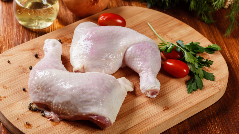 Raw chicken legs with tomatoes