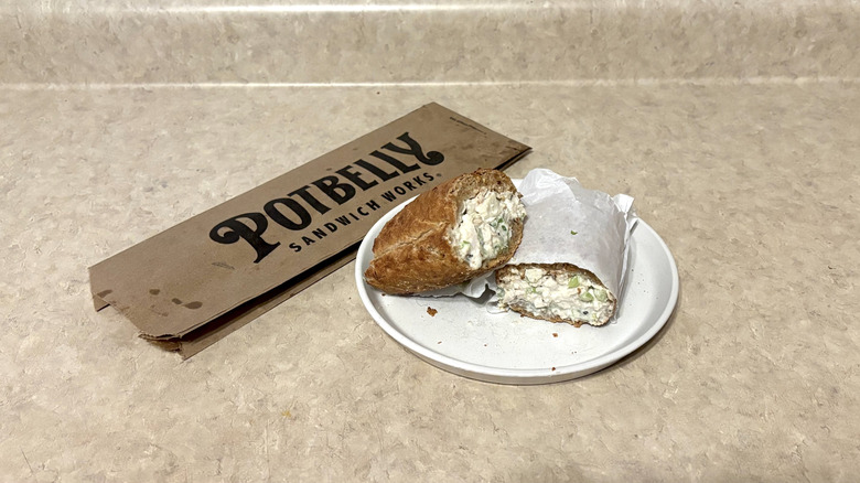 A chicken salad sub from Potbelly sits on a napkin.