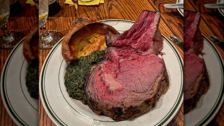 A plate of prime rib, Yorkshire pudding, and creamed spinach at Gulliver's