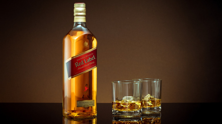 Johnnie Walker Red Label bottle alongside whisky glasses.