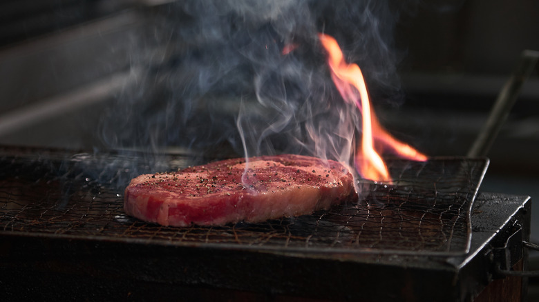 Steak cooking on a robata grill