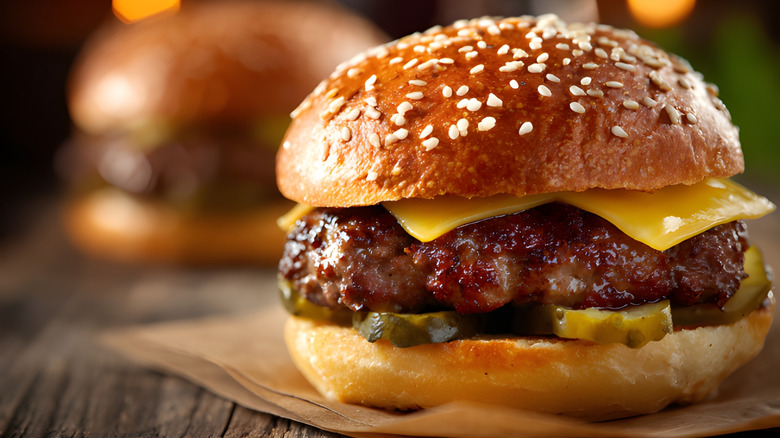 Juicy beef burger with cheese and pickles