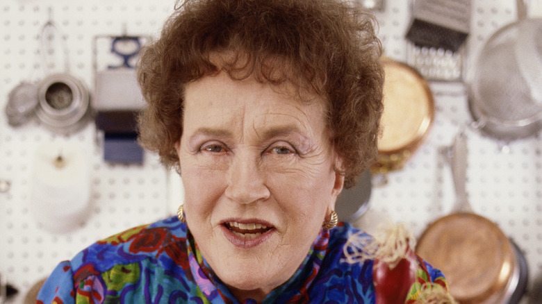 Julia Child in kitchen full of pots and pans