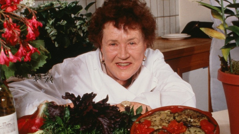 Julia Child smiling in kitchen