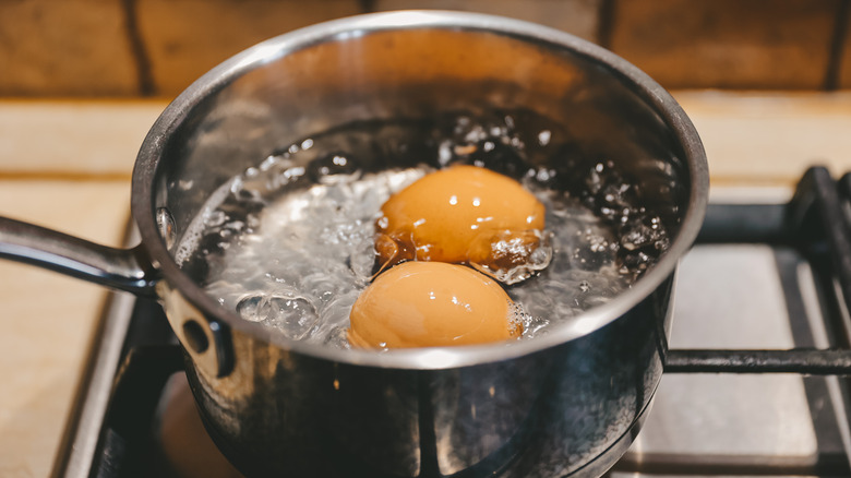 Saucepan with boiling eggs on a gas stove