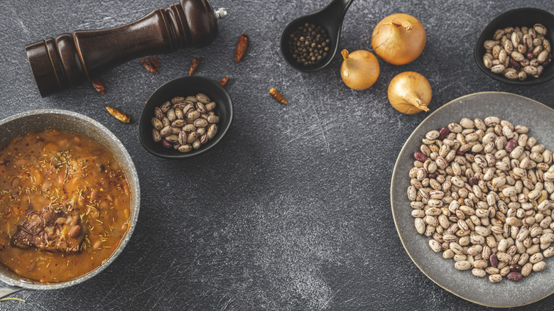 Bowl of cooked bean soup and dried beans