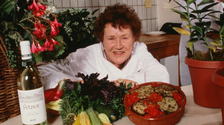 Legendary chef Julia Child surrounded by food and wine