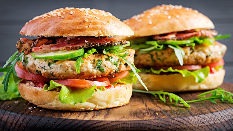 Two turkey burgers loaded with vegetables