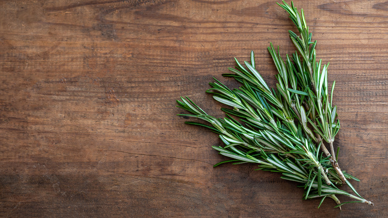 Fresh rosemary on a wooden table.