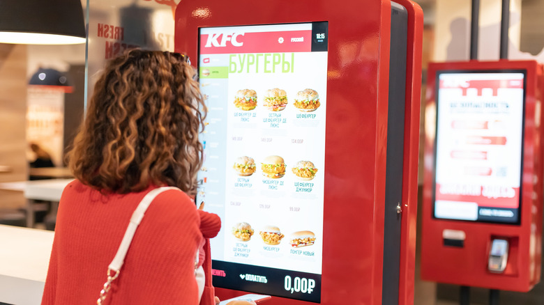 woman ordering from a KFC kiosk