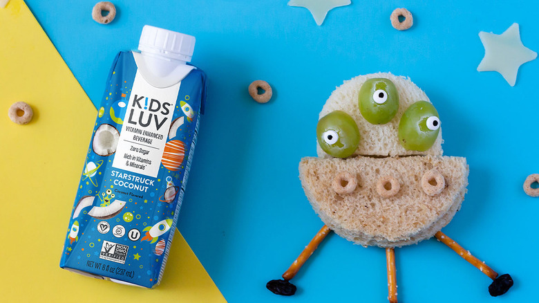 Tetra Pak container of KidsLuv vitamin beverage with alien made of bread and grapes