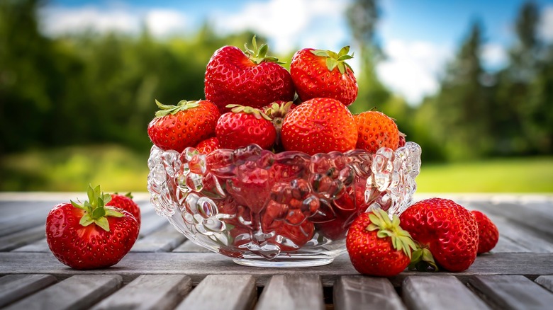 bowl of strawberries on table outside