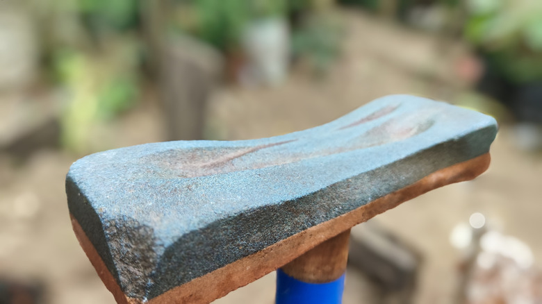 Closeup of a pitted and curved whetstone