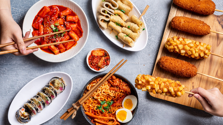 A plate setting of common korean food, including Korean corn dogs.