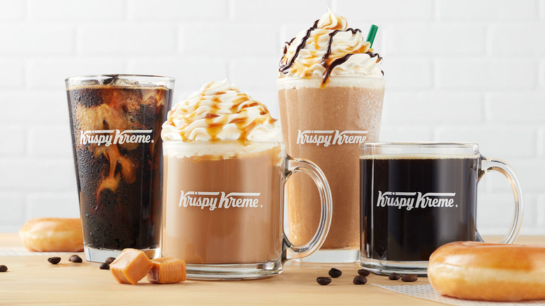 krispy kreme coffee drinks in glass mugs with donuts, caramels, and coffee beans