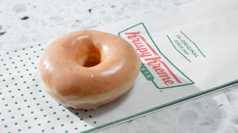Krispy Kreme donut on Krispy Kreme bag