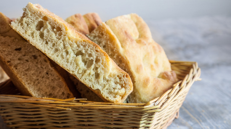 Slices of plain focaccia in wicker bread basket