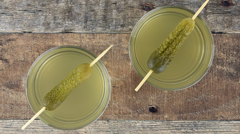 drinks with pickles on toothpicks as garnishes