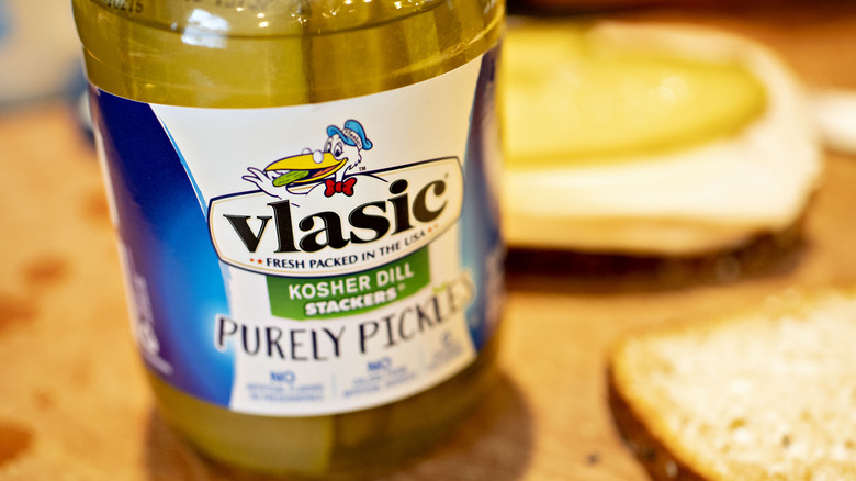 Jar of Vlasic pickles beside bread