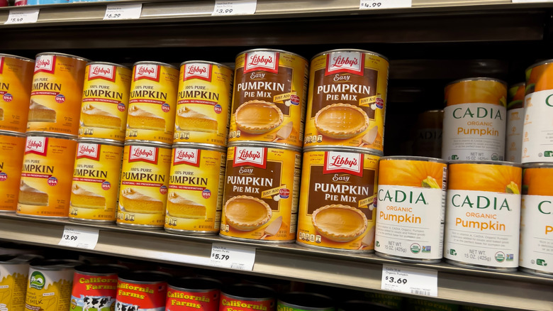 Cans of Libby's pure pumpkin and pumpkin pie mix on a store shelf