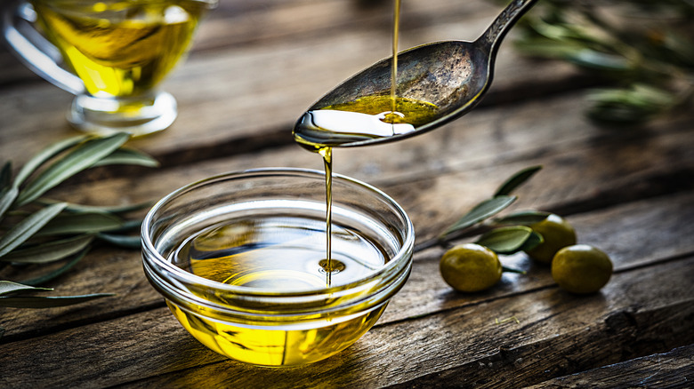 A bowl and a spoon of olive oil
