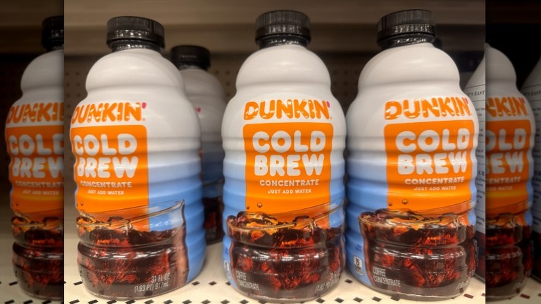 Bottles of Dunkin' Cold Brew sit on a grocery store's shelf