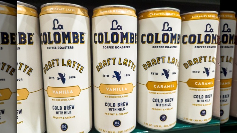 A row of canned La Colombe cold brew coffees sit on a grocery store's shelf