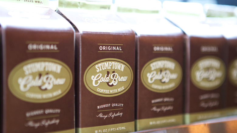 A row of Stumptown Cold Brew coffee cartons sit on a grocery store's shelf