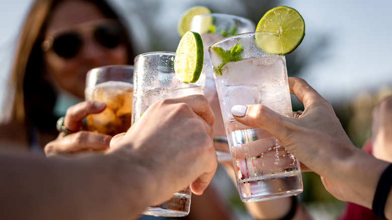friends cheering cocktails made with lime