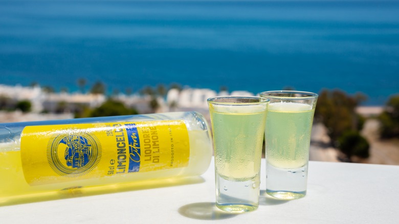 Limoncello bottle and glasses outside