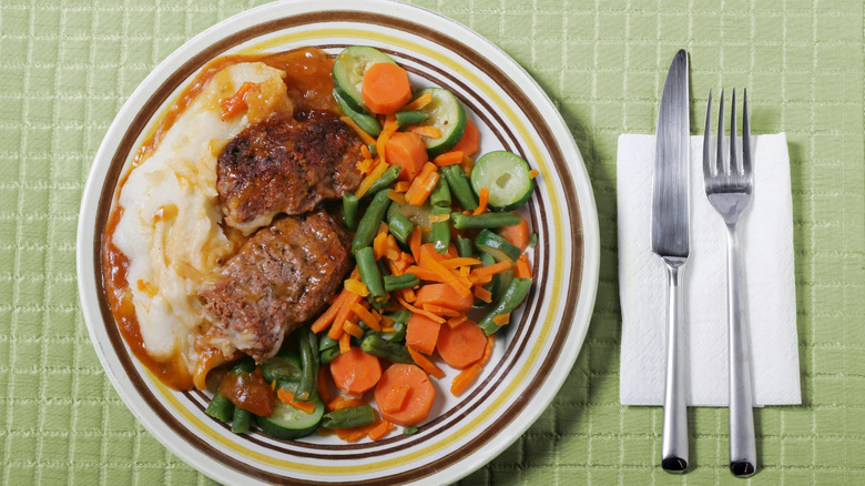 Retro dinner of meatloaf, mashed potatoes, and boiled vegetables
