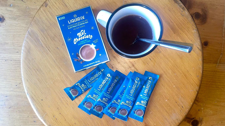 Overhead view of mug, packets, and box of Liquid I.V. Hydration Multiplier Hot Chocolate