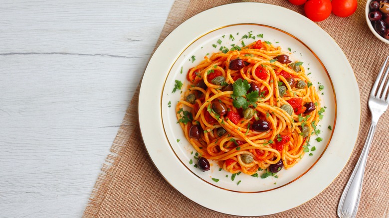 Spaghetti with tomato sauce, capers, and olives