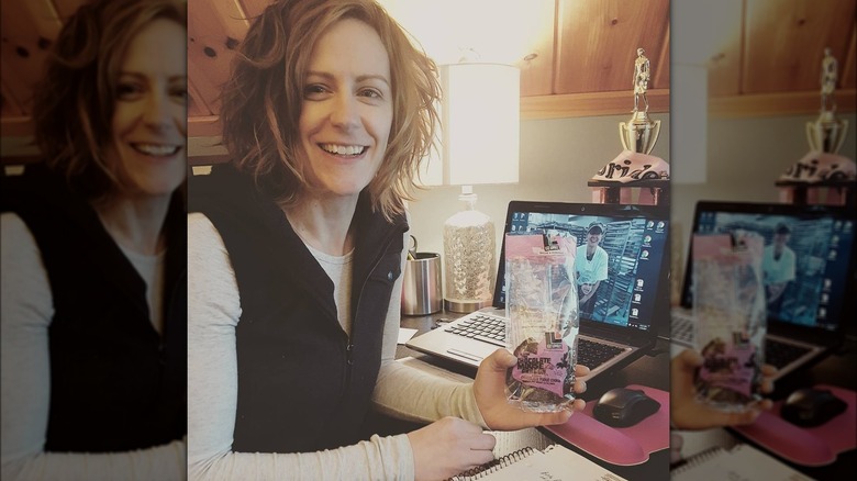 Liz Scott holding a package of Liz Lovely cookies