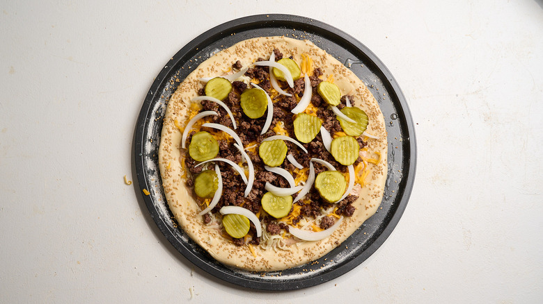 pizza topped with onion and pickles